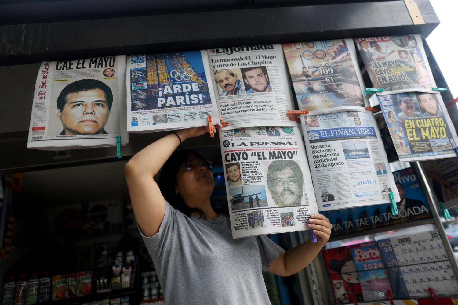 A newspaper seller arranges newspapers reporting the El Paso, Texas, U.S., arrest of Mexican drug lord Ismael "El Mayo" Zambada and Joaquin Guzman Lopez, "El Chapo" Guzman's son, in Mexico City, Mexico July 26, 2024.