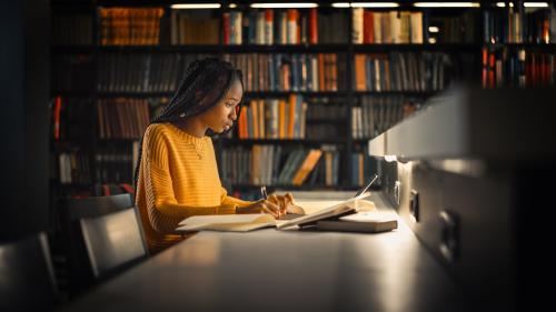 Young black woman working on a computer in a library