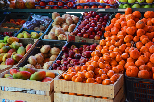 Fruits and vegetables in wooden boxes for sale at open Mexican market. boxes of fruit (think it conveys the "unpacking" in the title, and the idea of how "you can't compare apples to oranges"